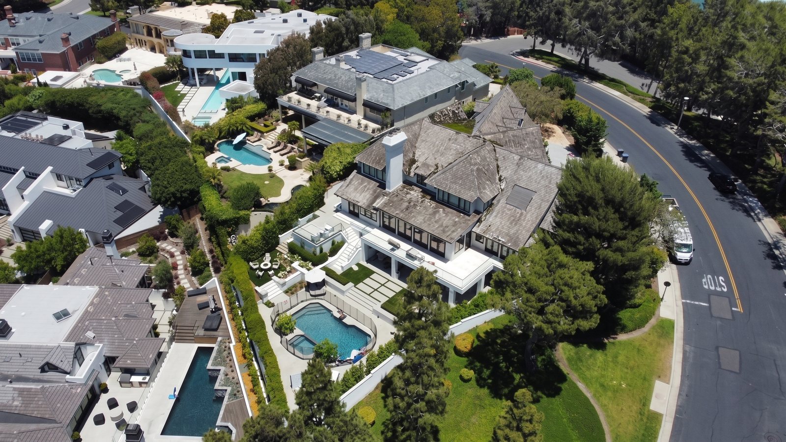 The same estate before the re-roof, with streaked and curling shingles