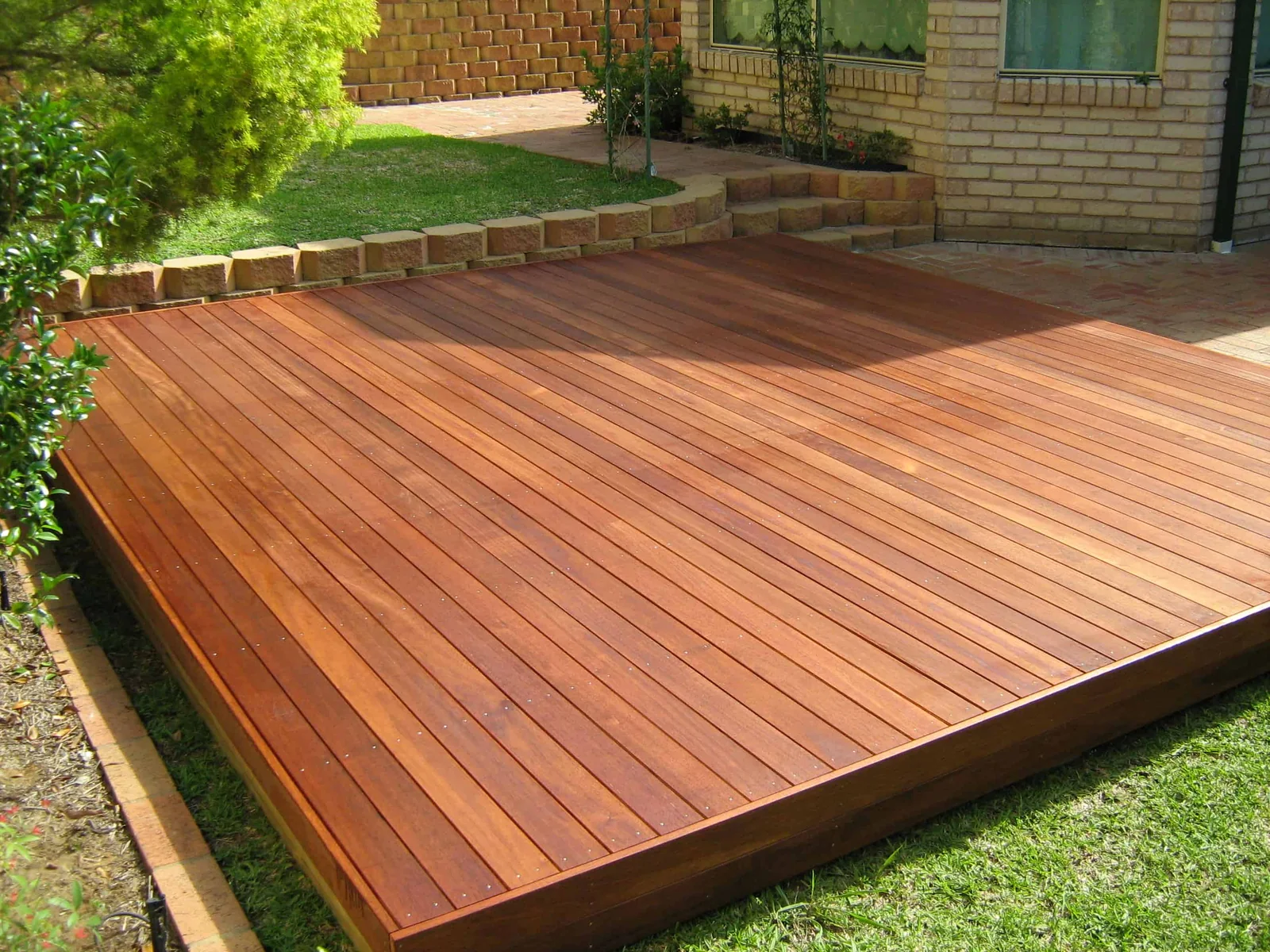 Floating hardwood deck in a landscaped backyard